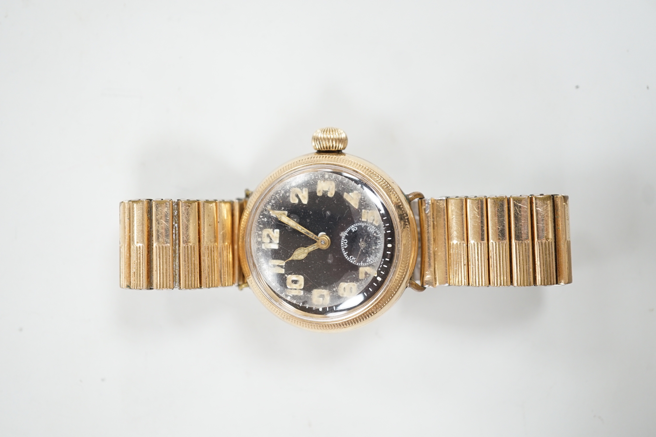 A gentleman's early 20th century 9ct gold Zenith military? manual wind wrist watch, with black Arabic dial and subsidiary seconds, case diameter 35mm, on associated later flexible strap.